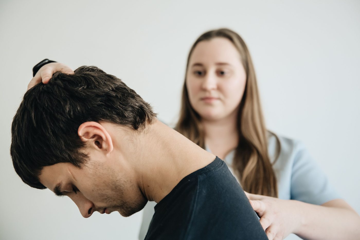 Therapist assessing a client's neck range of motion
